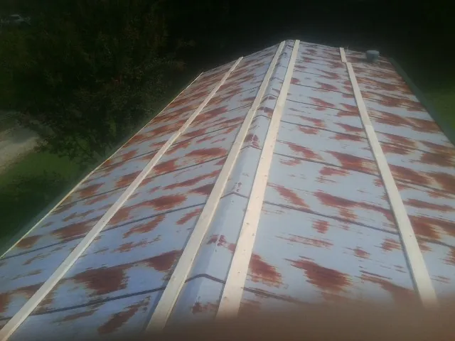 Rusted metal roof panels with new wood purlins before replacement — Storm Damage Roof Repair in Boonsboro by Roofing Brothers