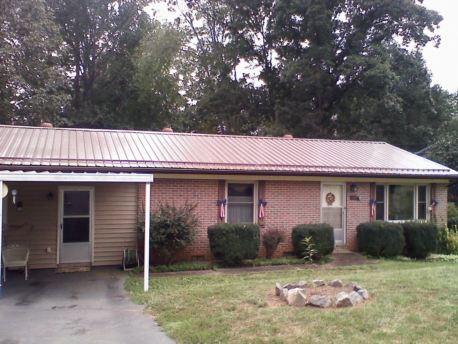 Bronze metal roof and carport on a brick ranch home — Roof Repair work by our crew in Boonsboro